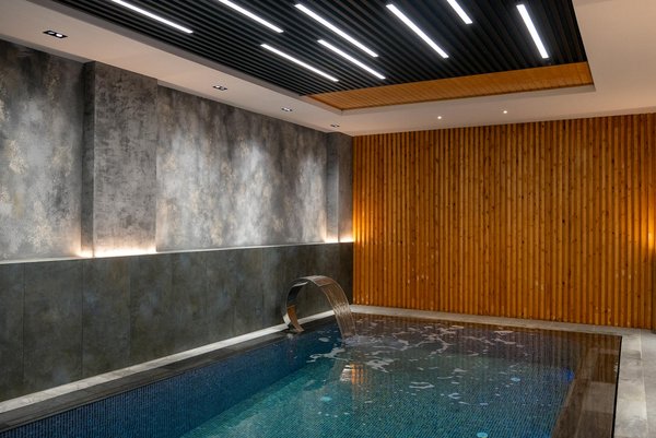 How can you ensure proper drainage around your home swimming pool?